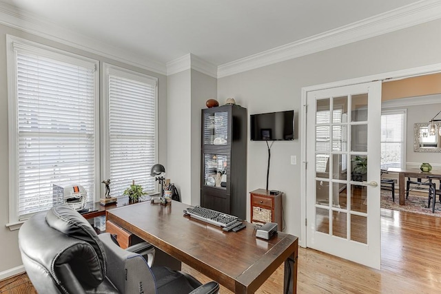 office with ornamental molding, light hardwood / wood-style flooring, and french doors