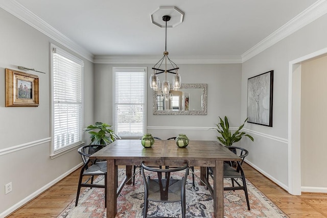 dining space featuring hardwood / wood-style floors, a notable chandelier, and ornamental molding