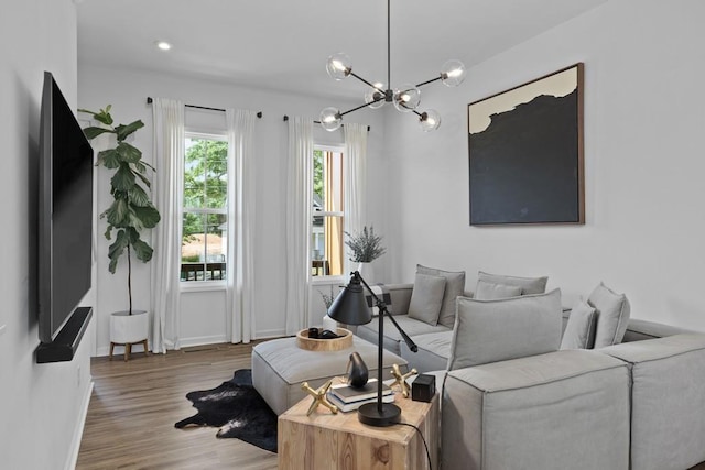 living room with wood-type flooring and a chandelier