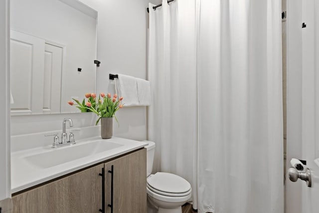 bathroom featuring toilet and vanity