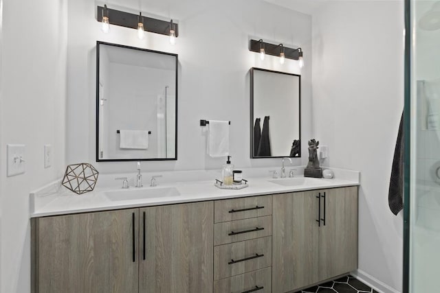 bathroom featuring a shower with shower door, tile patterned floors, and vanity