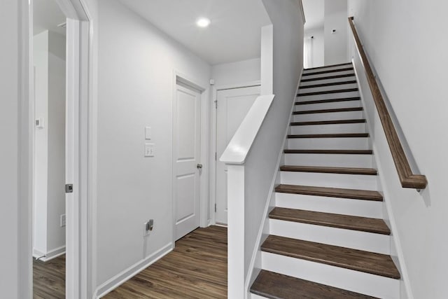 staircase with hardwood / wood-style flooring