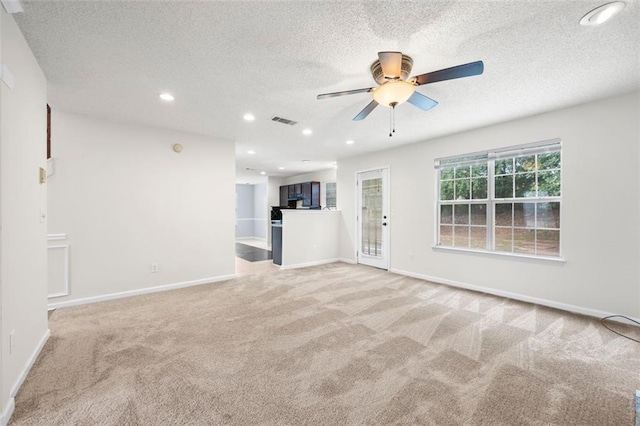 1486 Rogers Crossing Dr, Lithonia, GA 30058 - unfurnished living room featuring carpet floors, ceiling fan, a textured ceiling, baseboards, and recessed lighting