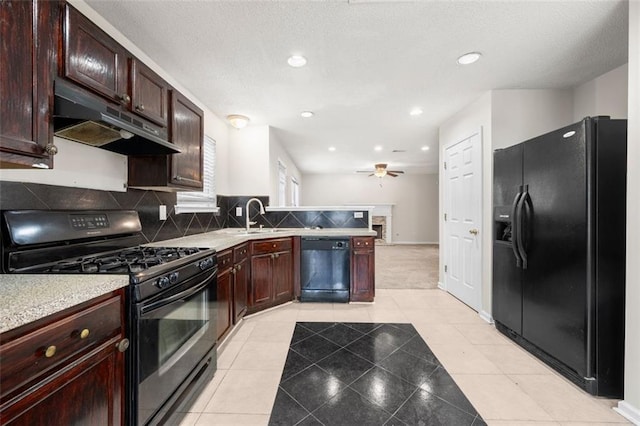1486 Rogers Crossing Dr, Lithonia, GA 30058 - kitchen featuring black appliances, under cabinet range hood, a sink, light countertops, and a peninsula