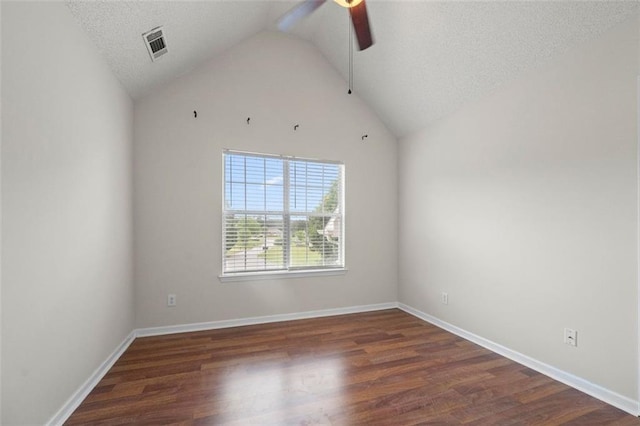 1486 Rogers Crossing Dr, Lithonia, GA 30058 - spare room with ceiling fan, vaulted ceiling, wood finished floors, baseboards, and a textured ceiling