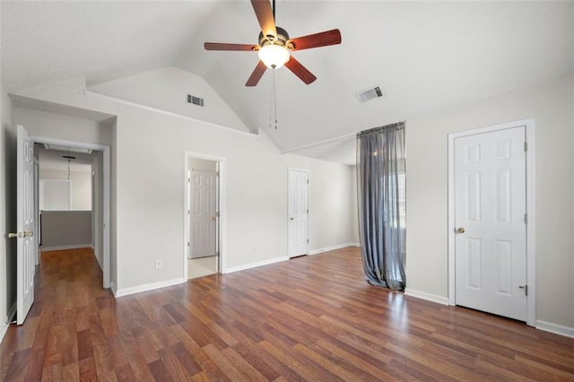 1486 Rogers Crossing Dr, Lithonia, GA 30058 - unfurnished bedroom with wood finished floors, vaulted ceiling, baseboards, and ceiling fan