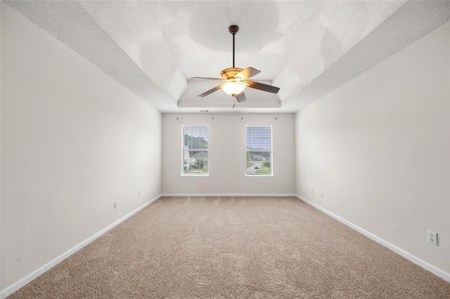 1486 Rogers Crossing Dr, Lithonia, GA 30058 - empty room with ceiling fan, light carpet, a raised ceiling, a textured ceiling, and baseboards