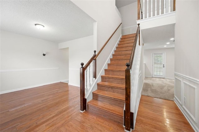 1486 Rogers Crossing Dr, Lithonia, GA 30058 - stairway with wood finished floors and a textured ceiling