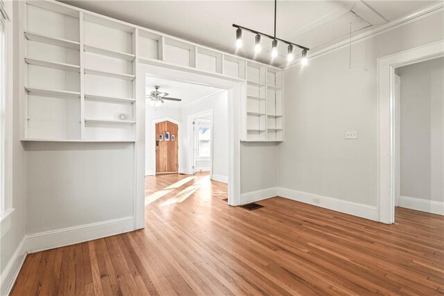 interior space featuring ceiling fan, crown molding, and hardwood / wood-style flooring