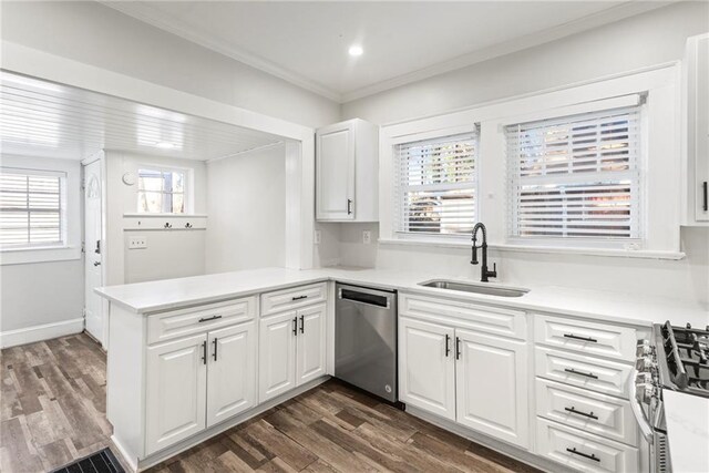 kitchen featuring kitchen peninsula, white cabinetry, sink, and stainless steel appliances