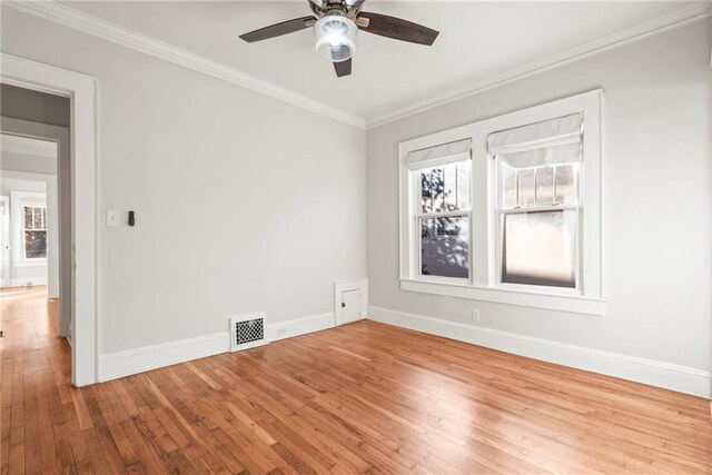 unfurnished room with ceiling fan, light wood-type flooring, and ornamental molding