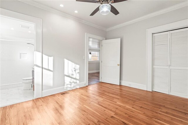 unfurnished bedroom with connected bathroom, ceiling fan, crown molding, and wood-type flooring