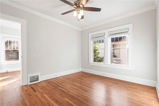 spare room with ceiling fan, hardwood / wood-style floors, and ornamental molding