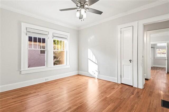 unfurnished room with hardwood / wood-style flooring, ceiling fan, and ornamental molding