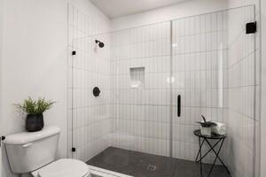 bathroom with walk in shower and toilet