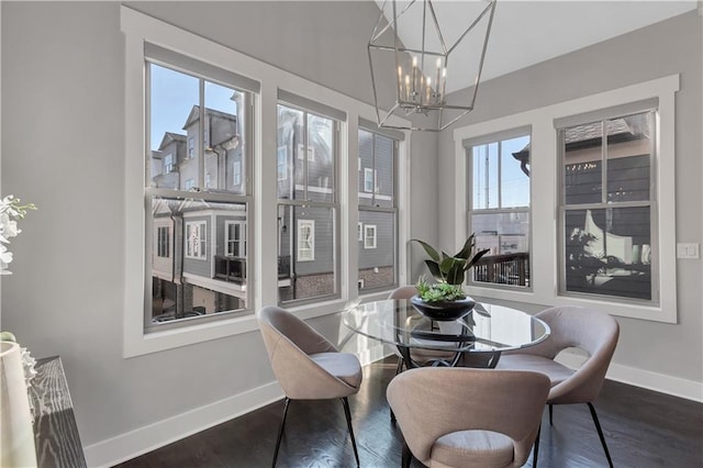 dining room featuring an inviting chandelier and dark hardwood / wood-style flooring