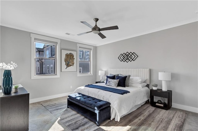 carpeted bedroom with crown molding and ceiling fan