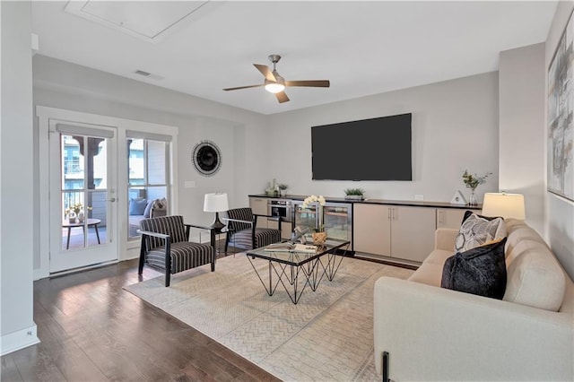 living room with wood-type flooring, beverage cooler, and ceiling fan