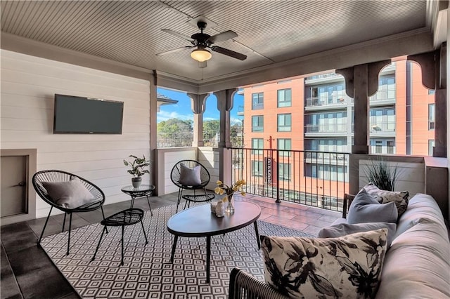 sunroom / solarium featuring ceiling fan