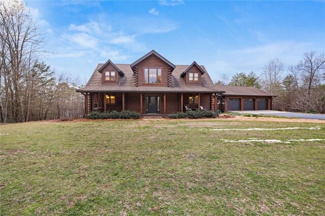 5505 Whitehall Rd, Lula, GA 30554 - log-style house with driveway, log exterior, a front lawn, covered porch, and a garage