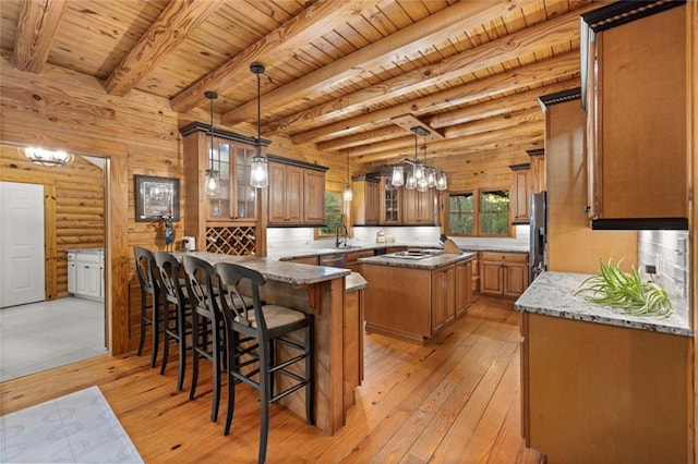 5505 Whitehall Rd, Lula, GA 30554 - kitchen with a sink, brown cabinets, light wood-style floors, and a peninsula