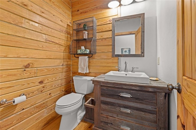 5505 Whitehall Rd, Lula, GA 30554 - bathroom with toilet, vanity, and wood walls