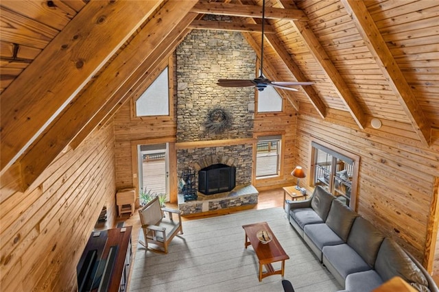5505 Whitehall Rd, Lula, GA 30554 - living area featuring wood walls, beamed ceiling, wood finished floors, a stone fireplace, and wood ceiling
