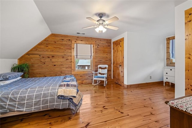 5505 Whitehall Rd, Lula, GA 30554 - bedroom featuring light wood-type flooring, wooden walls, visible vents, and vaulted ceiling