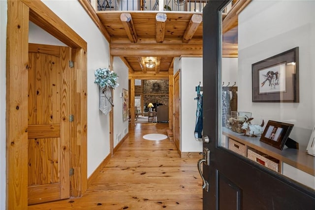 5505 Whitehall Rd, Lula, GA 30554 - hall with baseboards, log walls, beam ceiling, light wood-style floors, and wood ceiling