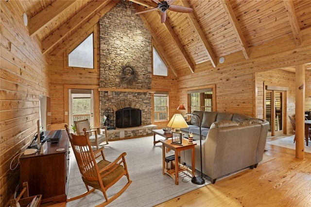 5505 Whitehall Rd, Lula, GA 30554 - living room featuring lofted ceiling with beams, wood walls, wood finished floors, a ceiling fan, and wood ceiling