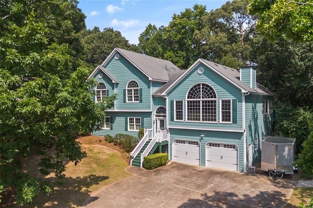 533 Coolsprings Walk, Woodstock, GA 30188 - raised ranch with driveway, an attached garage, stairs, and a chimney
