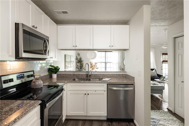 448 Teal Ct, Roswell, GA 30076 - kitchen with visible vents, appliances with stainless steel finishes, a sink, white cabinets, and dark wood-style floors
