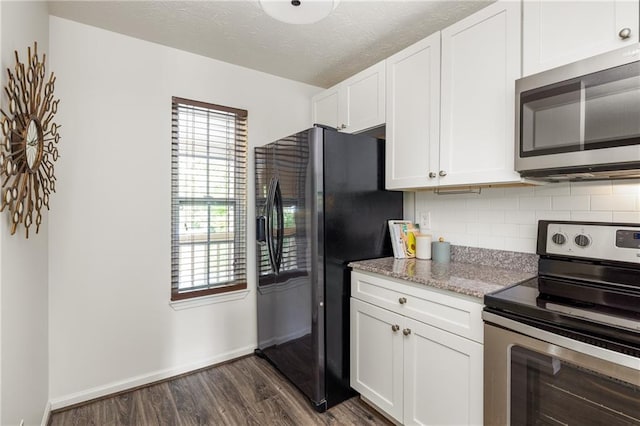 448 Teal Ct, Roswell, GA 30076 - kitchen featuring backsplash, appliances with stainless steel finishes, dark wood finished floors, baseboards, and white cabinets