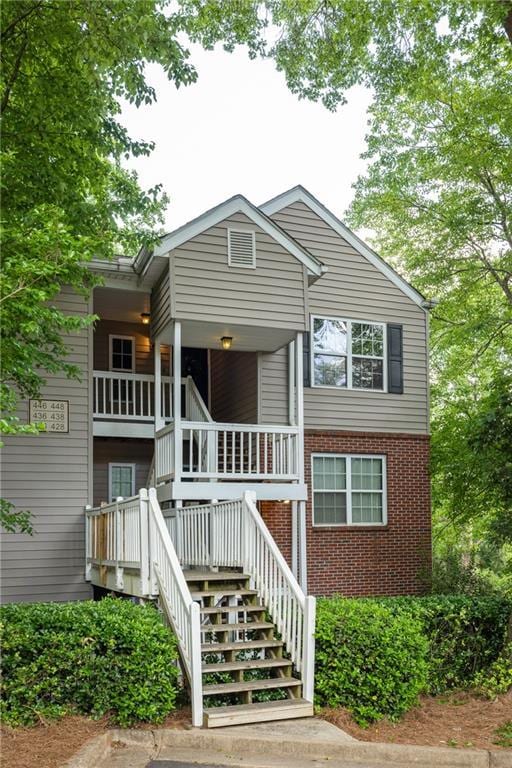 448 Teal Ct, Roswell, GA 30076 - view of front facade featuring stairs, covered porch, and brick siding