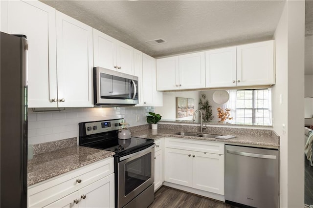 448 Teal Ct, Roswell, GA 30076 - kitchen with white cabinets, tasteful backsplash, a sink, stone counters, and stainless steel appliances