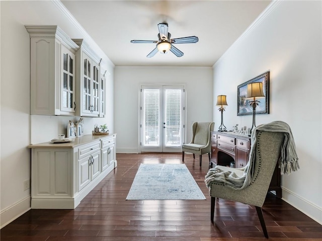 sitting room with ornamental molding, dark hardwood / wood-style floors, ceiling fan, and french doors