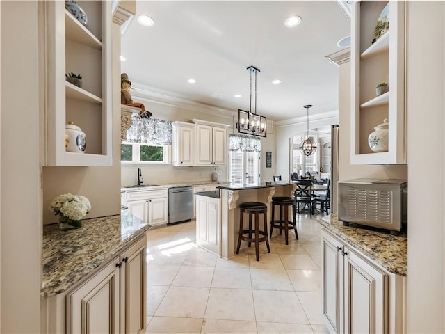 kitchen featuring dark stone counters, a kitchen breakfast bar, dishwasher, and a kitchen island