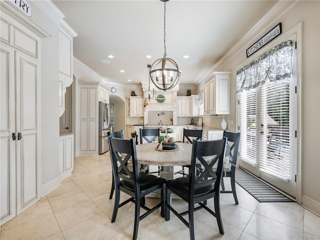 tiled dining area with crown molding, sink, and a notable chandelier