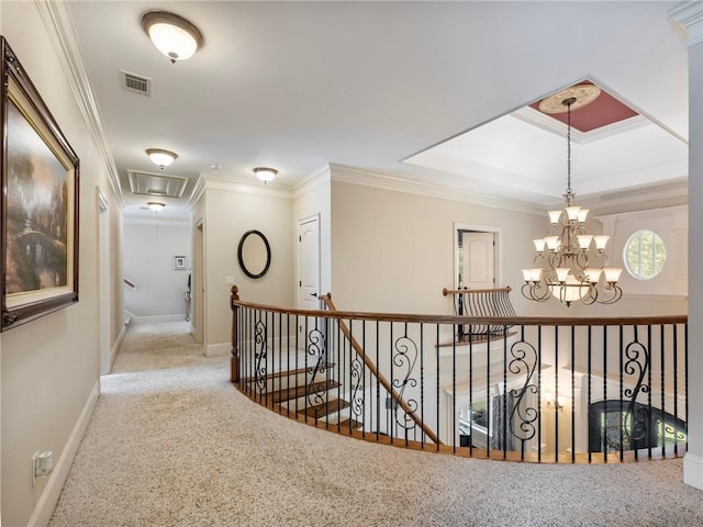 hallway featuring crown molding, a chandelier, and carpet flooring