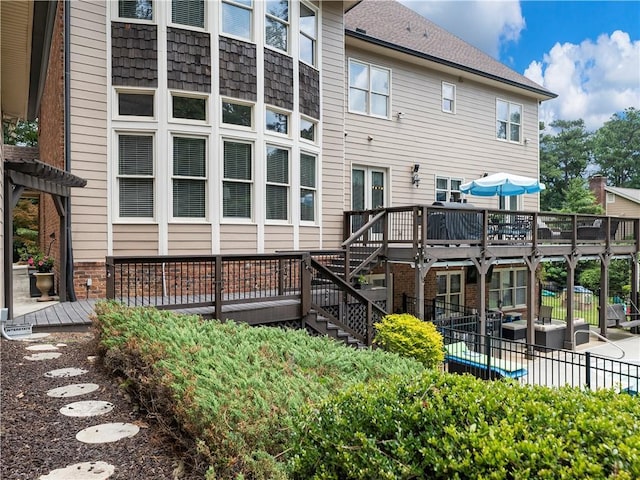 back of house with a wooden deck