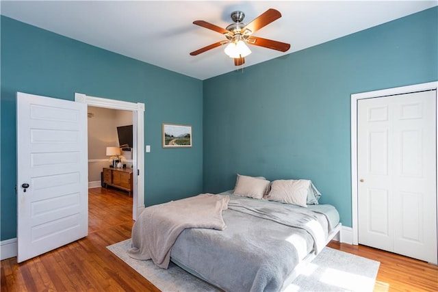 bedroom featuring baseboards and wood finished floors