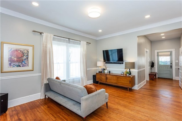 living area with ornamental molding, recessed lighting, baseboards, and hardwood / wood-style flooring