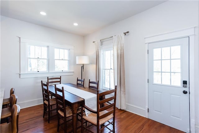 dining room with baseboards, wood finished floors, and recessed lighting