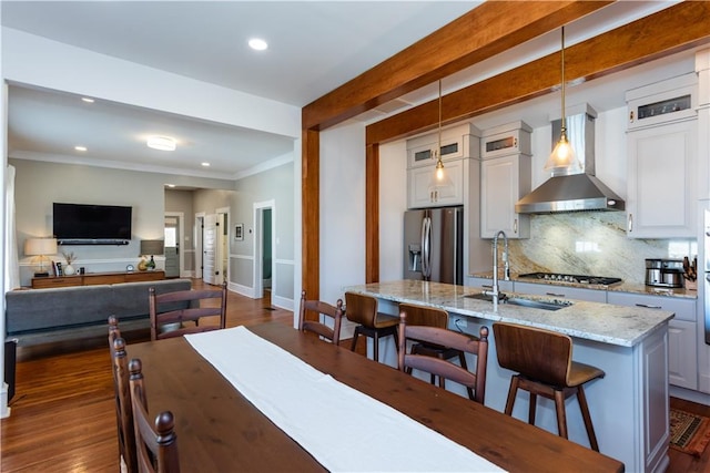 dining room with dark wood-style floors, recessed lighting, beamed ceiling, and ornamental molding