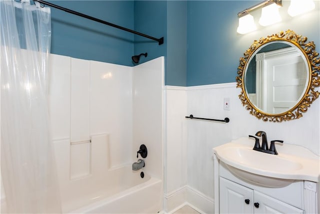 full bath with wainscoting, shower / tub combo with curtain, and vanity