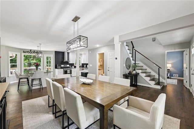 4733 Eidson Rd, Dunwoody, GA 30360 - dining space featuring stairway, dark wood finished floors, baseboards, and a chandelier