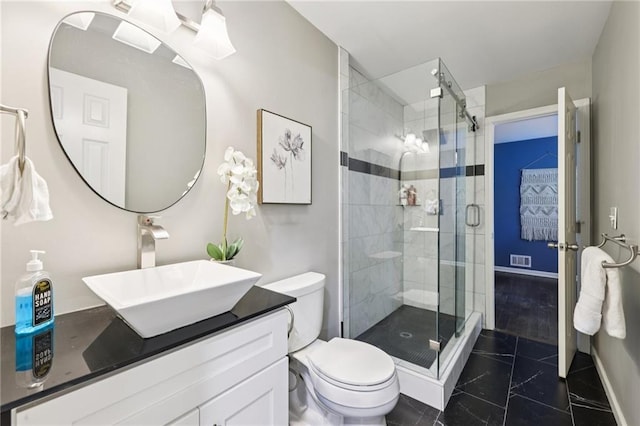 4733 Eidson Rd, Dunwoody, GA 30360 - full bathroom with vanity, toilet, a shower stall, and baseboards