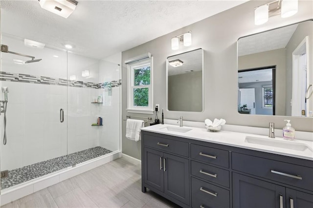 4733 Eidson Rd, Dunwoody, GA 30360 - bathroom with a shower stall, double vanity, a textured ceiling, and baseboards