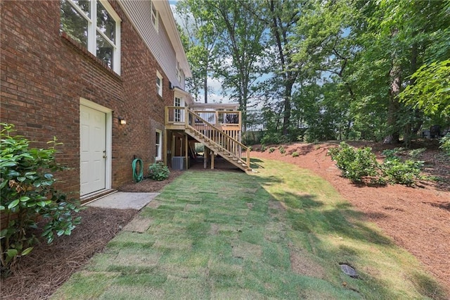 4733 Eidson Rd, Dunwoody, GA 30360 - view of green lawn featuring stairs, a wooden deck, and central air condition unit