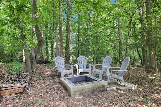 4733 Eidson Rd, Dunwoody, GA 30360 - view of yard featuring an outdoor fire pit and a wooded view